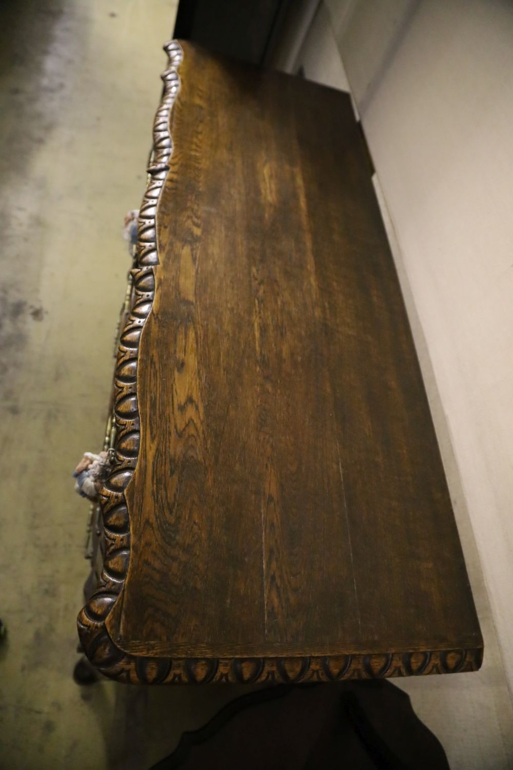 A 20th century French oak commode, fitted four long drawers with carved decoration, width 122cm, depth 43cm, height 92cm